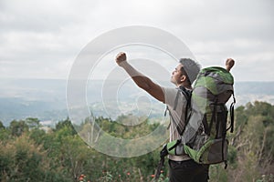 Man hiking in nature raise his arm