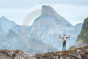 Man hiking in Norway traveler happy raised hands enjoying mountain view traveling backpacking outdoor