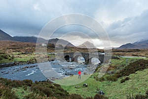 Man hiking through Scottish Highlands