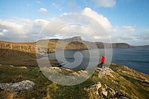 Man hiking through Scottish Highlands along rugged coastline