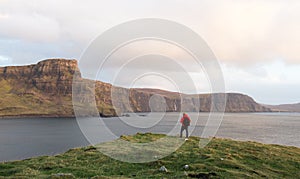 Man hiking through Scottish Highlands along rugged coastline