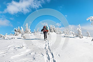 Man hiking on snow in mountains