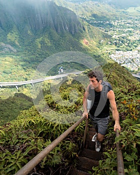 Man Hiking Stairway to Heaven (Haiku Stairs) on Oahu, Hawaii.