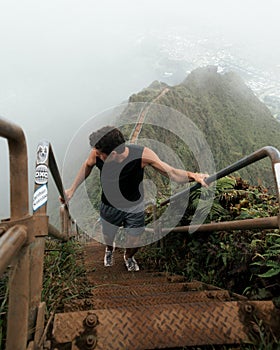 Man Hiking Stairway to Heaven (Haiku Stairs) on Oahu, Hawaii.