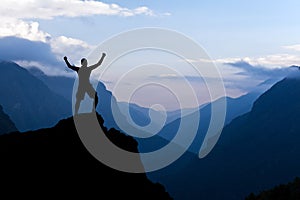 Man hiking success silhouette in mountains