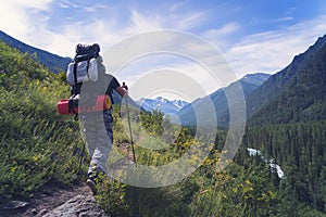 Man hiking at sunset mountains with heavy backpack Travel Lifestyle wanderlust adventure concept summer vacations outdoor alone in