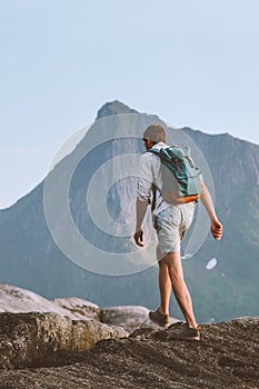 Man hiking traveling alone in Norway vacations backpacking eco tourism in mountains photo