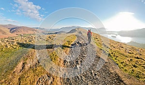 Man hiking up a steep path on Catbells mountain in The Lake District