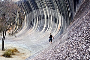 Man hiking on the Wave rock in Hyden Western Australia