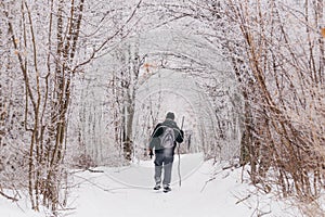 Man hiking in winter on a snow trail