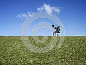 Man on hillside with computer