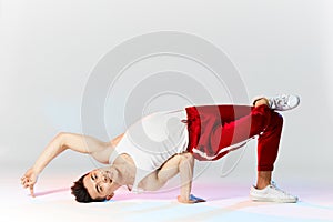 A man hip hop dancer or bboy freezes in one pose on the hand photo