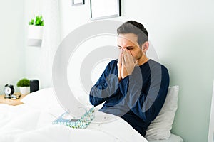 Man in his 30s staying in bed because of the fever