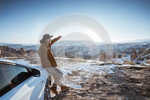 man on his adventure going to beautiful hill in cappadocia by his car