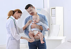 Man with his baby visiting children`s doctor