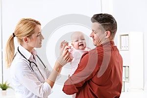 Man with his baby visiting children`s doctor