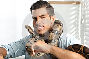 Man with his boa constrictor. Exotic pet