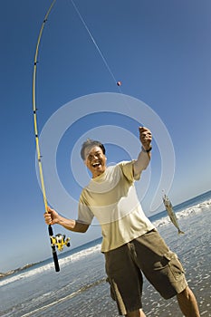 Man With His Catch On The Beach