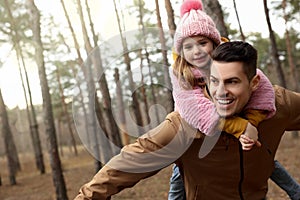 Man and his daughter spending time together in forest