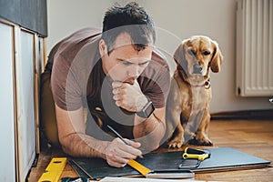 Man and his dog doing renovation work at home