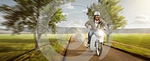 Man with his dog riding a moped at top speed
