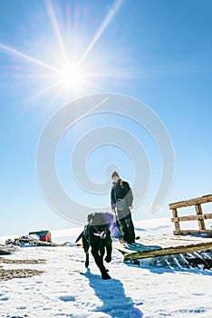 Man and his dog in the snowy mountains