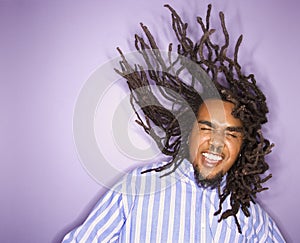 Man with his dreadlocks in motion.