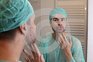 Man with his face all marked and ready for plastic surgery