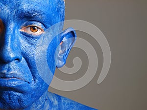 Man with his face painted with color blue (2)