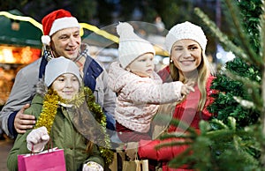 Man and his family buying Christmas tree