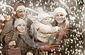 Man and his family buying Christmas tree