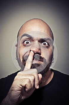 Man with his finger in the nose