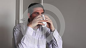 Man in his forties (40s) drinking a hot drink