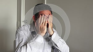 Man in his forties (40s) sitting at a table upset