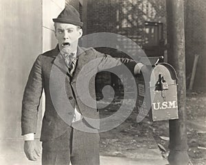 Man with his hand stuck in mailbox