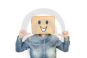 Man with his head in a box and laughing gesture drawn on it with thums up photo