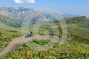 Man on his mountain bike going down the path from Jochpass