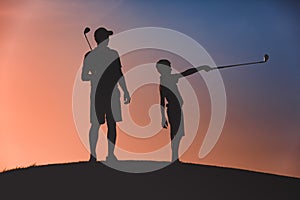 Man with his son golfers silhouette