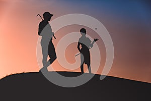 Man with his son golfers silhouette