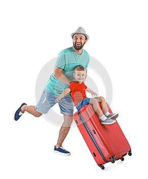 Man and his son playing with suitcase