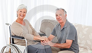 Man with his wife in a wheelchair