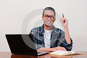 A man on his working place smiling confidence at the camera photo