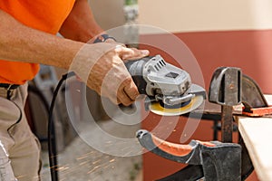 A man in his yard is engaged in locksmith work. Hobby, in a home workshop.