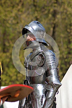 Man in historical costume (a knight) prepares for a battle.