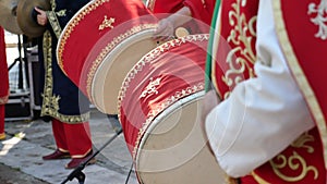 A man hit the ancient drum with Musical Instrument.