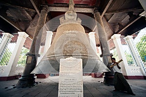 Man hitting the Mingun bell in Myanmar.