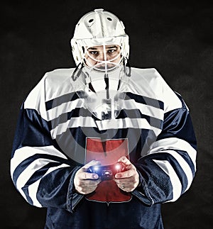 Man in hockey sport dress plays esports.Electronic sports are popular.