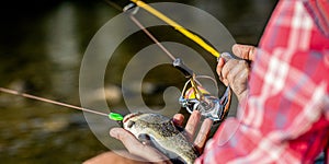 Man hold big fish trout in his hands. Fisherman and trophy trout. Man holding a trout fish. Fisherman hand holding