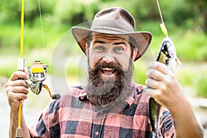 Man hold big fish trout in his hands. Fisherman and trophy trout. Man holding a trout fish. Fishing. Angler with fishing