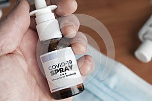 Man hold a bottle of covid-19 spray made with monoclonal antibodies